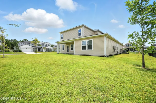a living room with furniture a rug and a flat screen tv