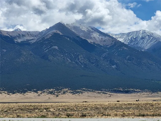 a view of a wooden floor with a mountain in the background