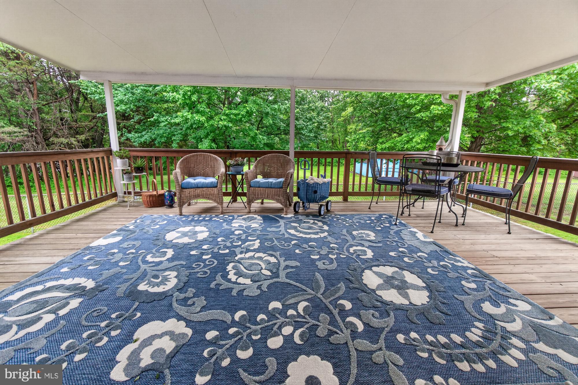 5601 Woodville Road Mount Airy, MD 21771 - Photo 17 of 54 a view of a patio with a table chairs and a backyard