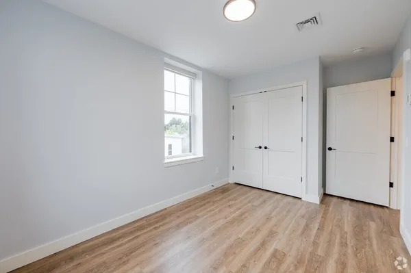 wooden floor in an empty room with a window