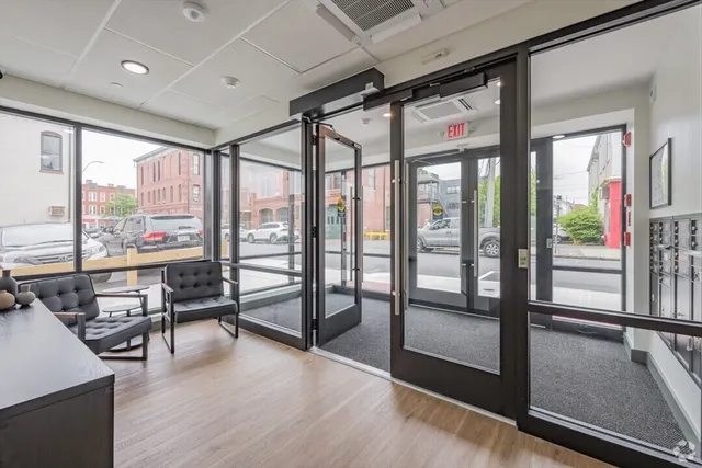 a view of a room with furniture and wooden floor