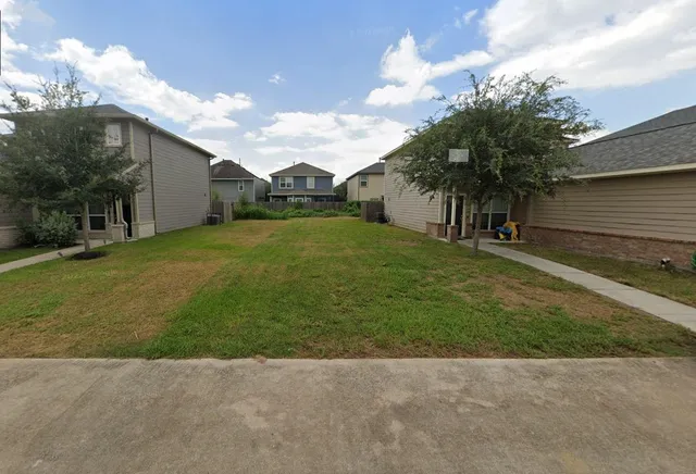 a backyard of a house with plants and a garden