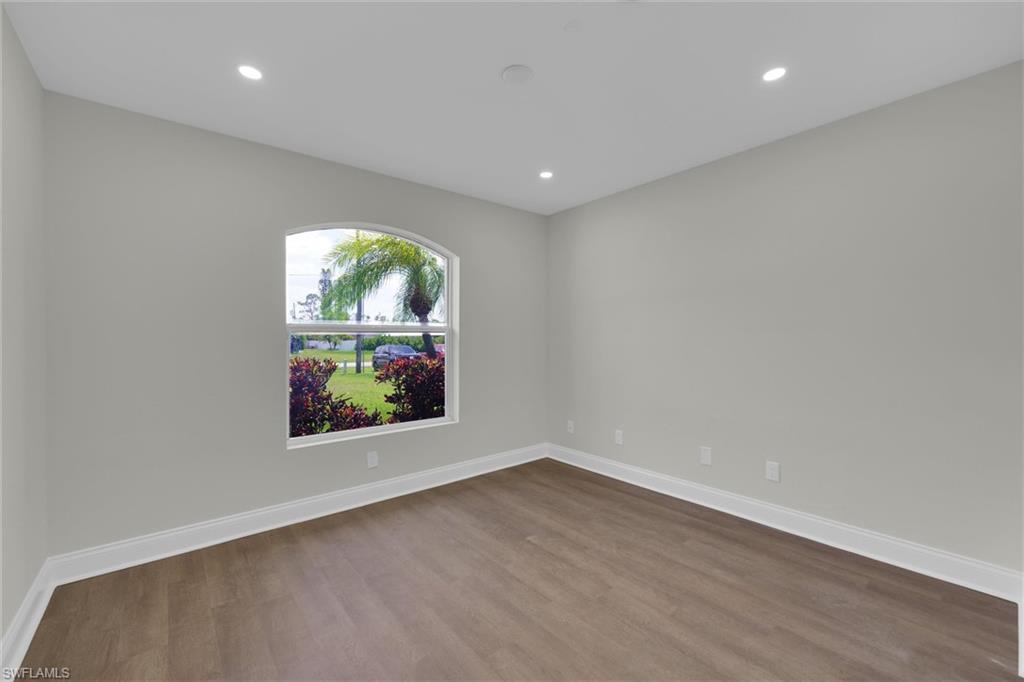 20620 Park Place Estero, FL 33928 - Photo 16 of 28 Empty room with dark wood-type flooring, baseboards, and recessed lighting