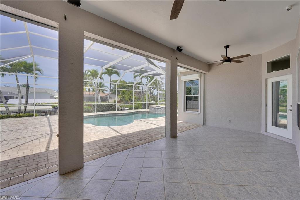 20620 Park Place Estero, FL 33928 - Photo 23 of 28 View of pool featuring a pool with connected hot tub, a lanai, a patio, and a ceiling fan