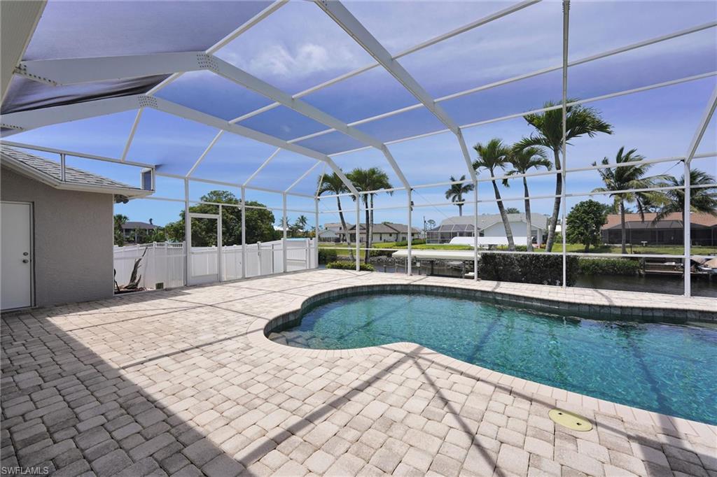 20620 Park Place Estero, FL 33928 - Photo 26 of 28 Outdoor pool featuring a patio area, a lanai, and a residential view