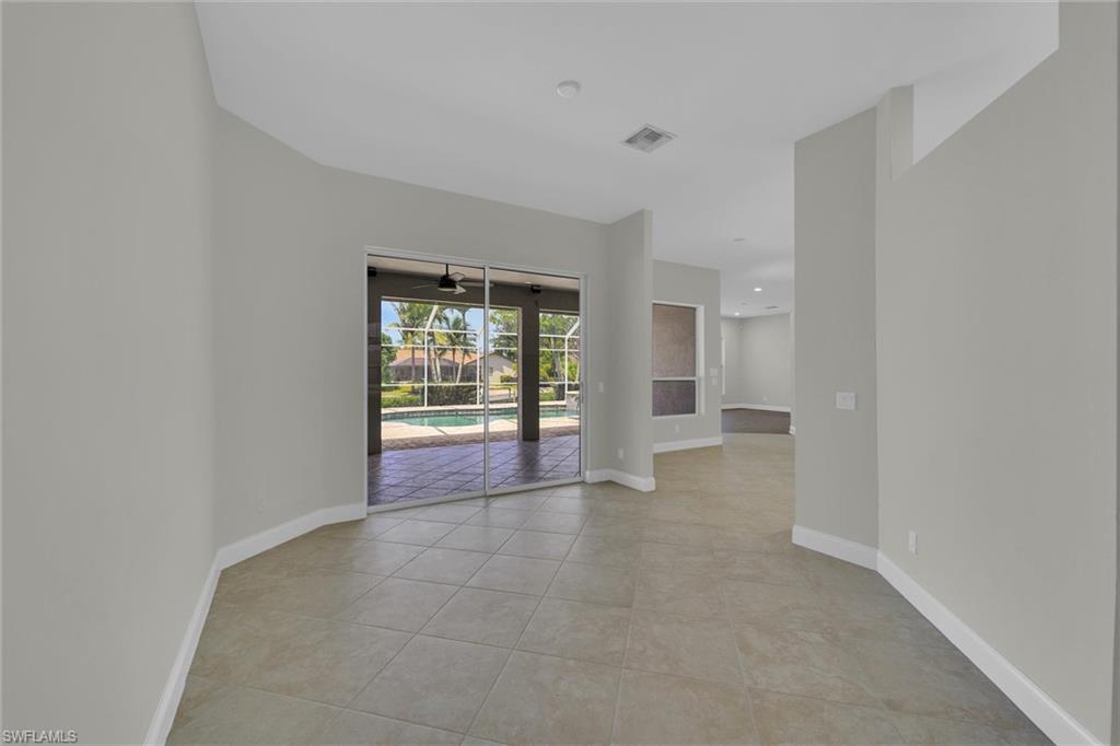 20620 Park Place Estero, FL 33928 - Photo 8 of 28 Unfurnished room featuring light tile patterned floors, baseboards, and a ceiling fan