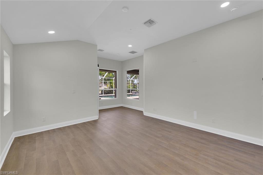 20620 Park Place Estero, FL 33928 - Photo 9 of 28 Unfurnished room with baseboards, visible vents, and wood finished floors
