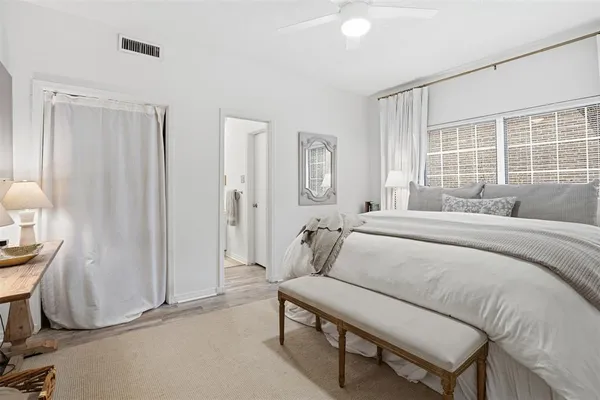 a bedroom with a bed a table and painting