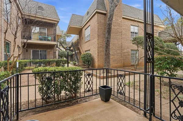 a view of balcony with small garden and wooden fence