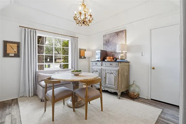 a view of a dining room with furniture and chandelier