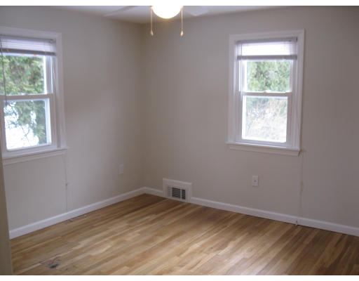 64 North Brook Road Springfield, MA 01119 - Photo 3 of 14 an empty room with wooden floor and windows