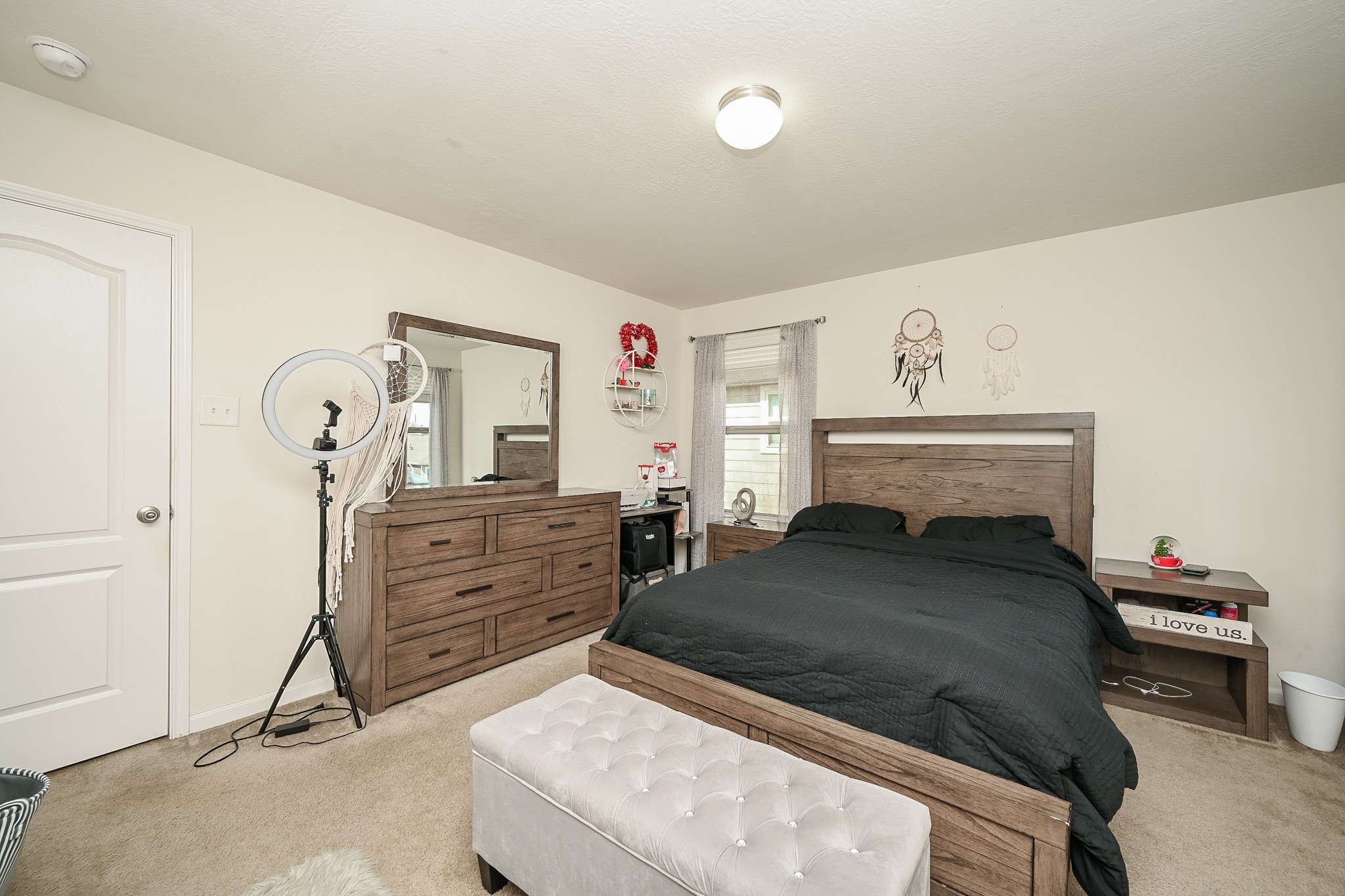 5238 Pine Forest Ridge Street Katy, TX 77493 - Photo 11 of 26 a bedroom with a bed and a chandelier