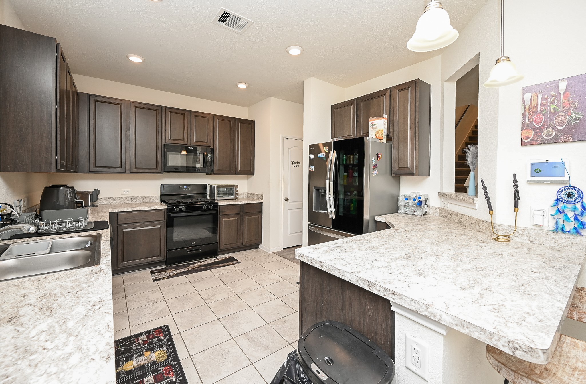 5238 Pine Forest Ridge Street Katy, TX 77493 - Photo 6 of 26 a kitchen with stainless steel appliances granite countertop a sink refrigerator and cabinets