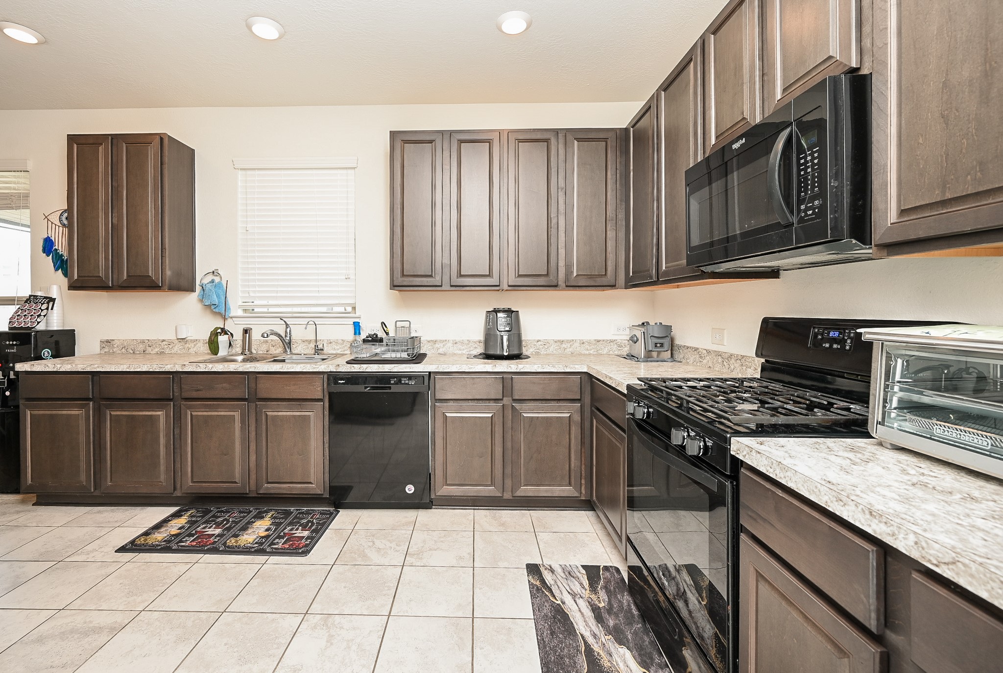 5238 Pine Forest Ridge Street Katy, TX 77493 - Photo 8 of 26 a kitchen with a sink stove top oven and cabinets