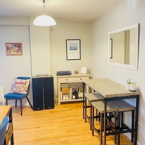 a view of a dining room with furniture and a chandelier