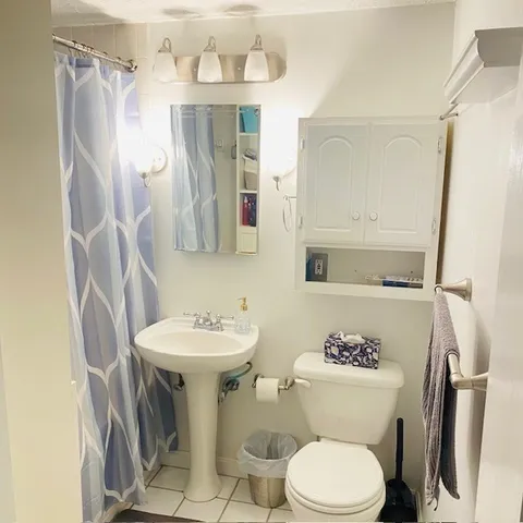a bathroom with a sink toilet and mirror