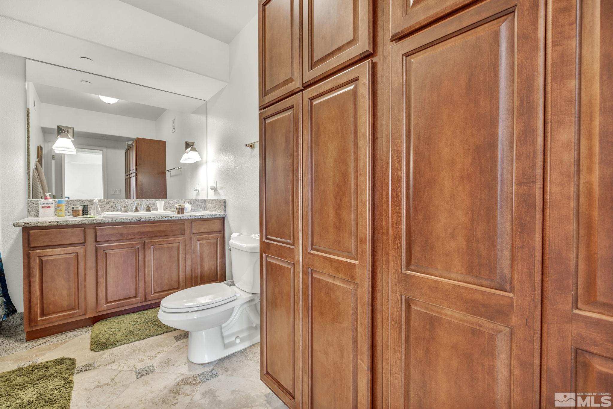 200 West 2nd Street, Unit 1207 Reno, NV 89501 - Photo 13 of 39 a bathroom with a toilet a sink and mirror