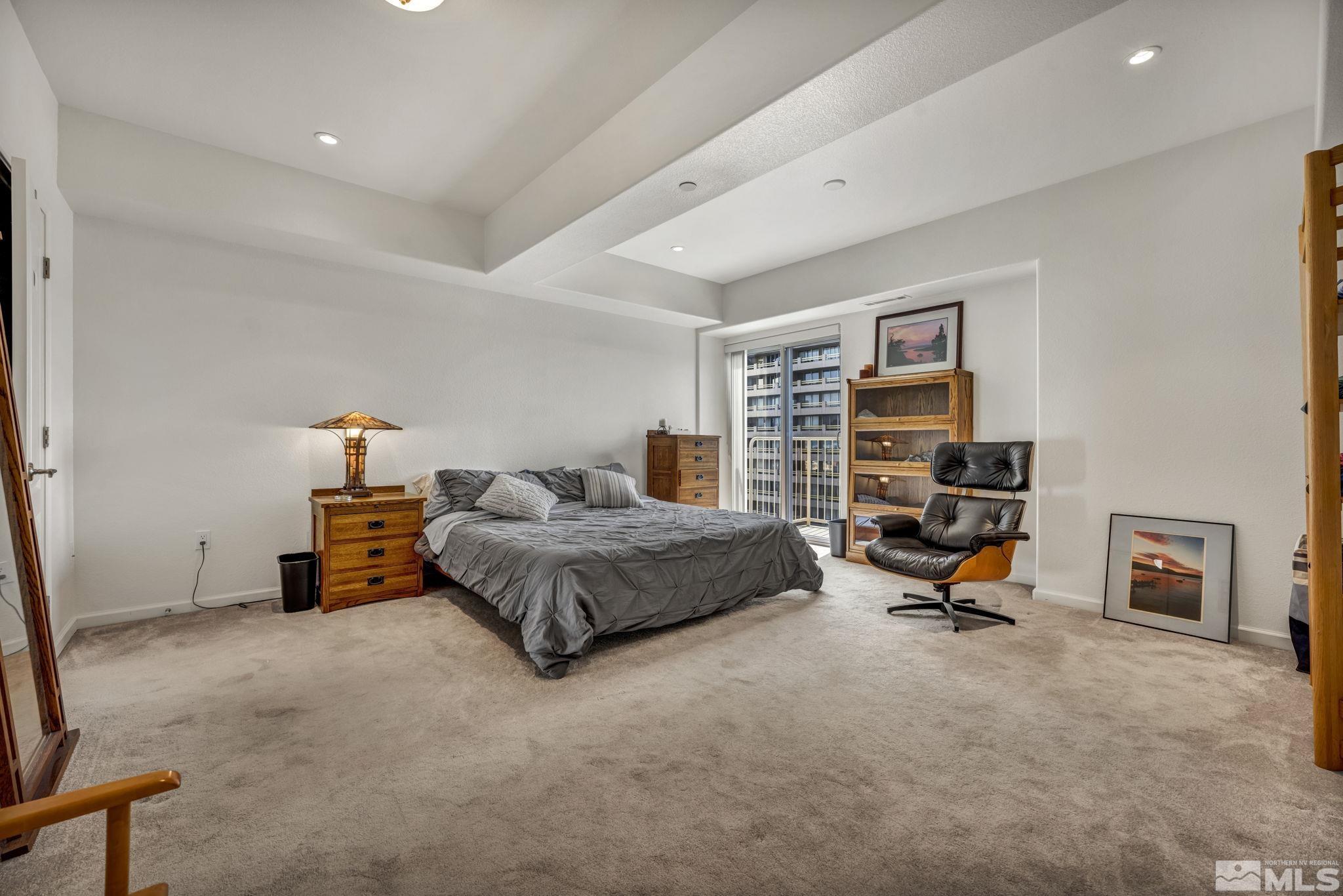 200 West 2nd Street, Unit 1207 Reno, NV 89501 - Photo 16 of 39 a bedroom with a bed a table and a couch