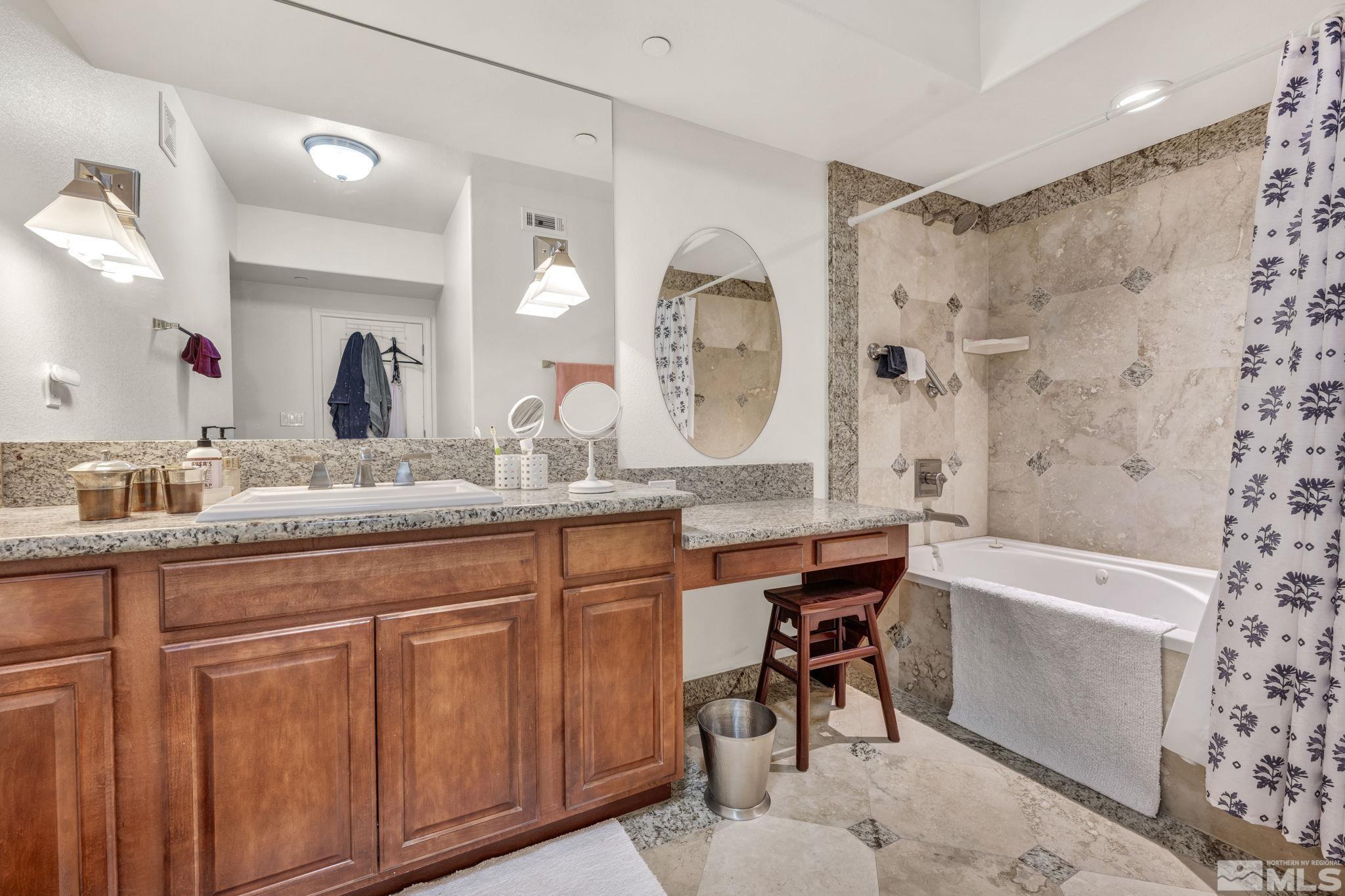200 West 2nd Street, Unit 1207 Reno, NV 89501 - Photo 20 of 39 a bathroom with a bathtub sink and a mirror