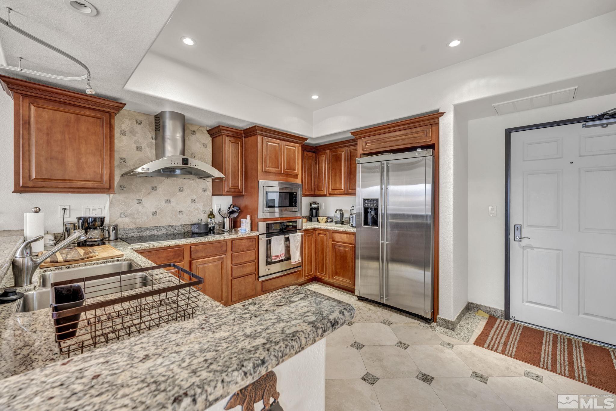 200 West 2nd Street, Unit 1207 Reno, NV 89501 - Photo 27 of 39 a kitchen with stainless steel appliances granite countertop a stove a sink and a refrigerator