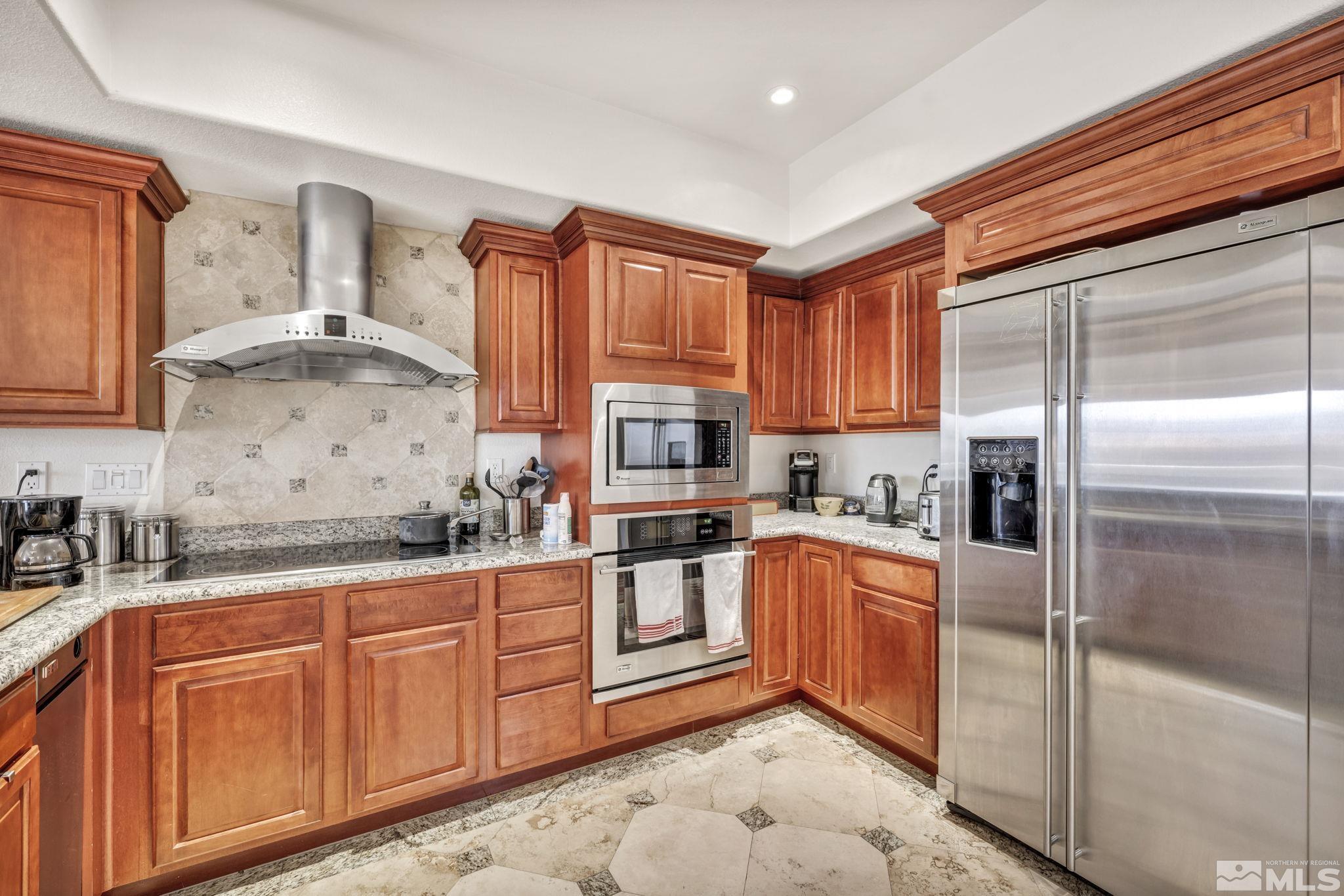 200 West 2nd Street, Unit 1207 Reno, NV 89501 - Photo 30 of 39 a kitchen with stainless steel appliances granite countertop a refrigerator sink and cabinets