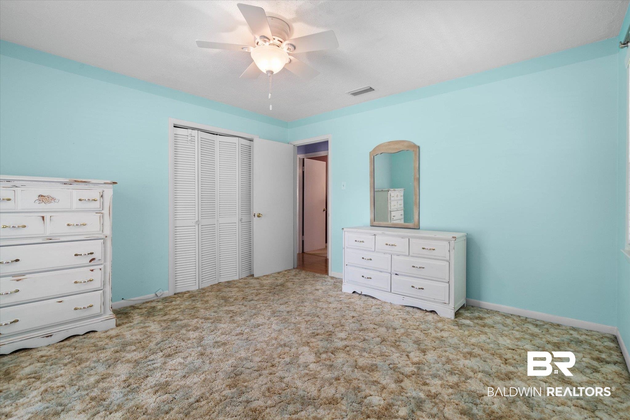 706 Sutherland Drive Chickasaw, AL 36611 - Photo 17 of 33 Bedroom featuring ceiling fan, carpet flooring, visible vents, and a closet