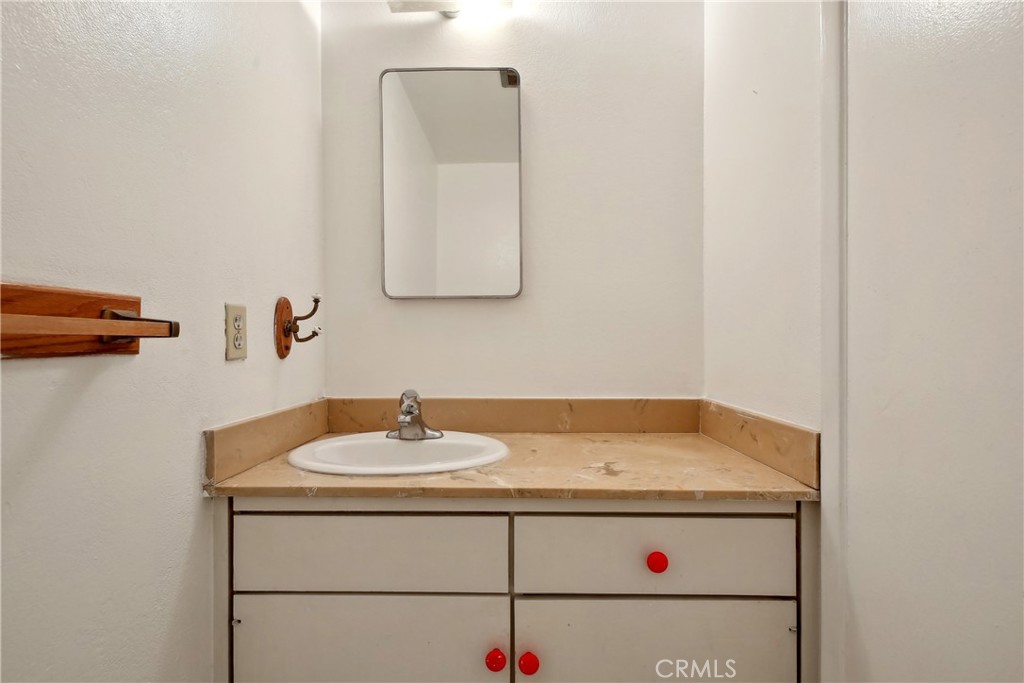 4018 Bryant Court Cypress, CA 90630 - Photo 8 of 16 a bathroom with a sink and a mirror