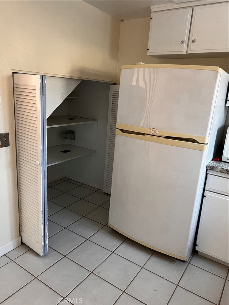 4018 Bryant Court Cypress, CA 90630 - Photo 9 of 16 a white refrigerator freezer and a dishwasher sitting in a kitchen