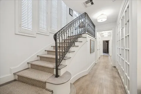 a view of entryway and hall with wooden floor