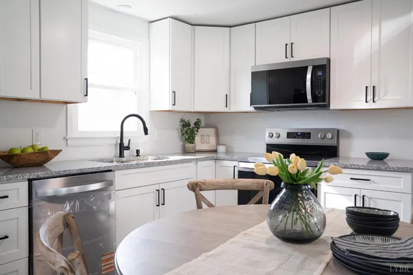 a kitchen with a stove a sink and a microwave