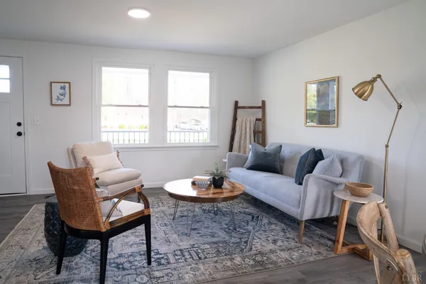 a living room with furniture a window and a table