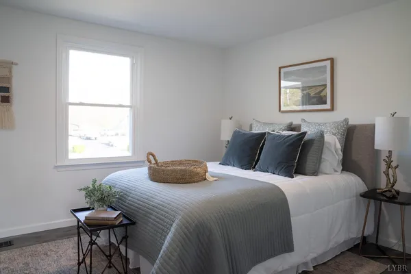 a bedroom with a bed and a table