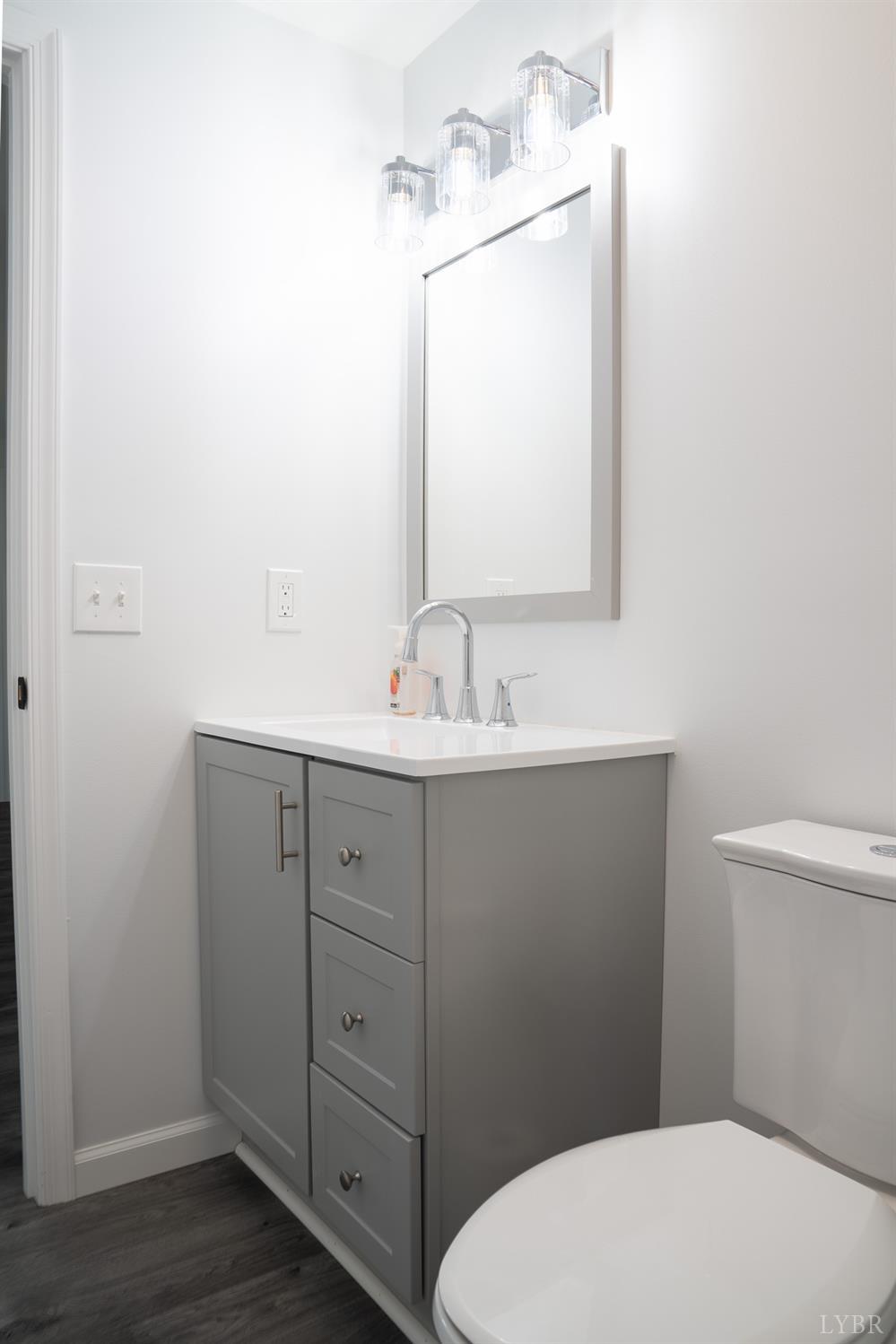 405 Spring Mill Road Concord, VA 24538 - Photo 18 of 28 a bathroom with a toilet sink vanity and mirror