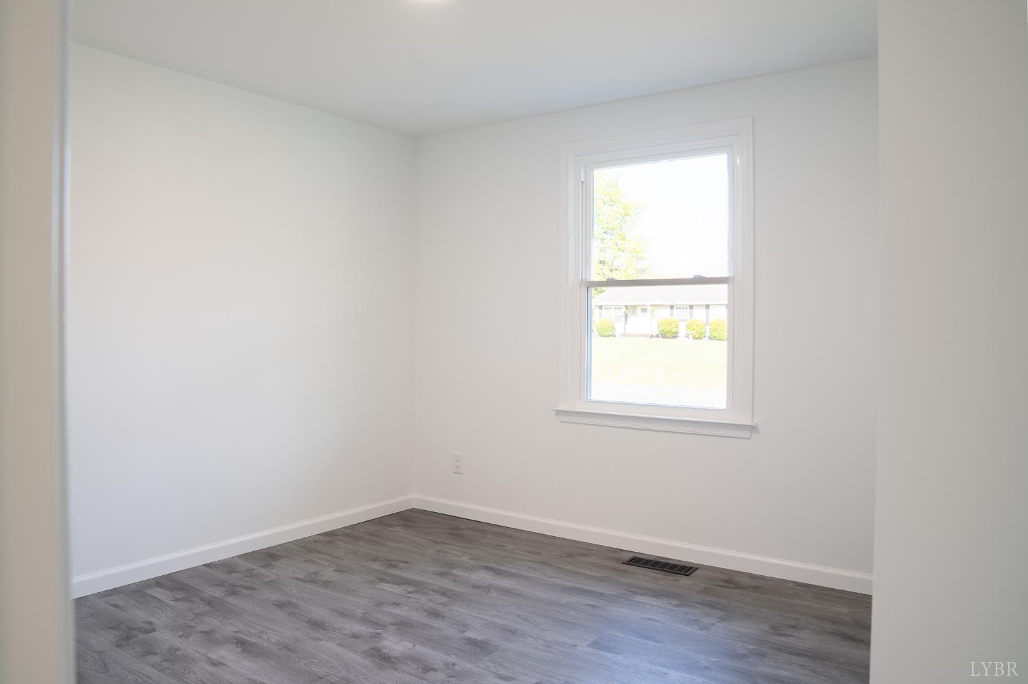 405 Spring Mill Road Concord, VA 24538 - Photo 20 of 28 an empty room with wooden floor and a window
