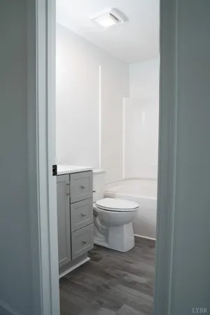 a bathroom with a toilet a sink and a vanity