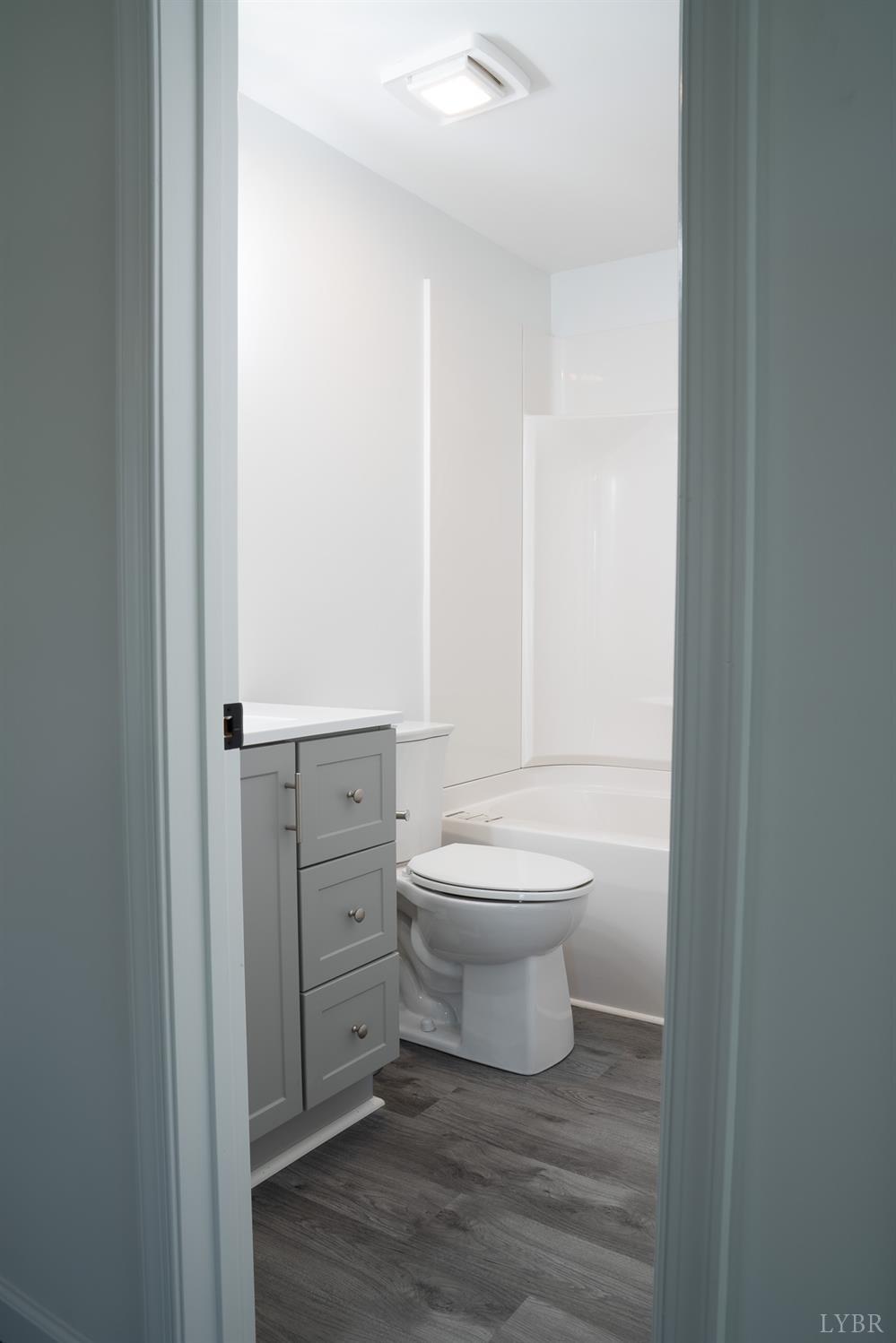 405 Spring Mill Road Concord, VA 24538 - Photo 22 of 28 a bathroom with a toilet a sink and a vanity