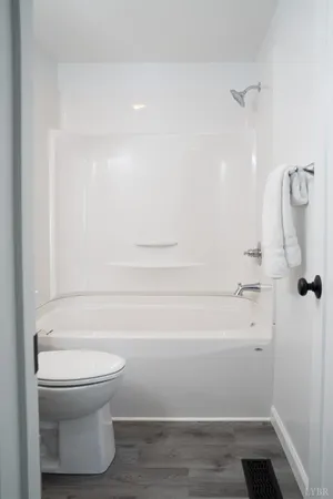 a bathroom with a toilet and a shower
