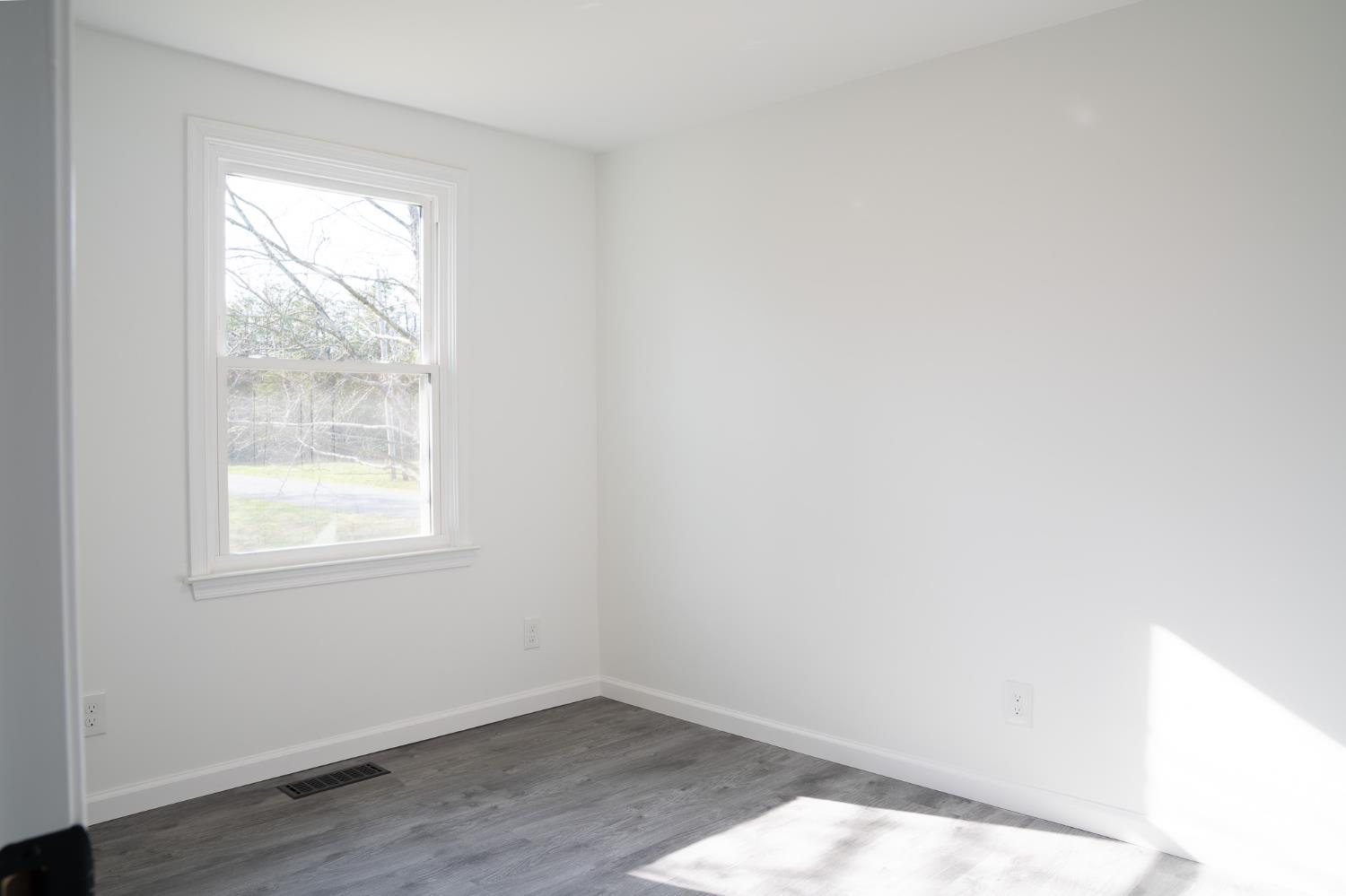 405 Spring Mill Road Concord, VA 24538 - Photo 24 of 28 an empty room with wooden floor and windows