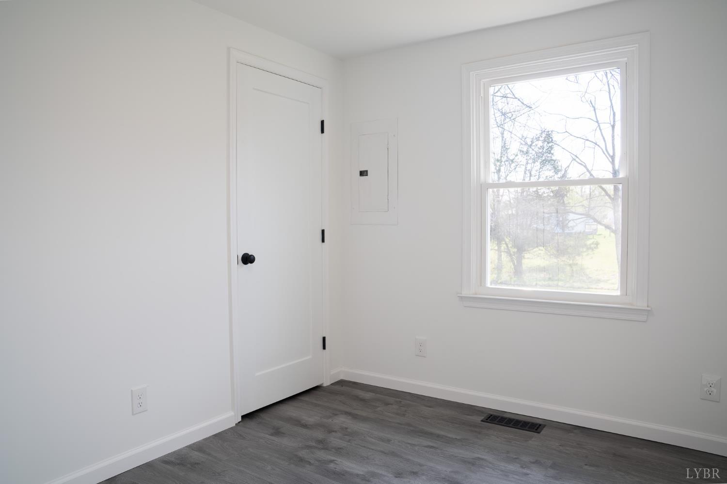 405 Spring Mill Road Concord, VA 24538 - Photo 25 of 28 an empty room with wooden floor and windows