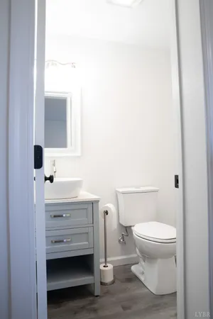 a bathroom with a toilet a sink and mirror
