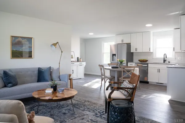 a living room with furniture and kitchen view