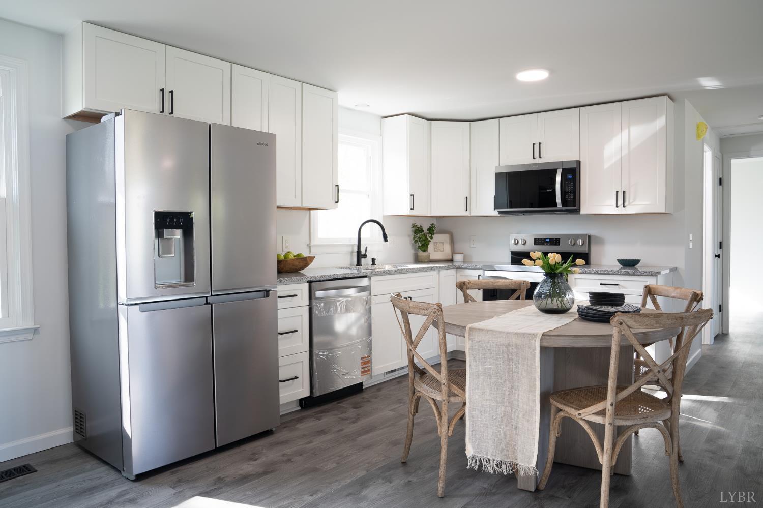 405 Spring Mill Road Concord, VA 24538 - Photo 10 of 28 a kitchen with stainless steel appliances a refrigerator stove microwave and cabinets