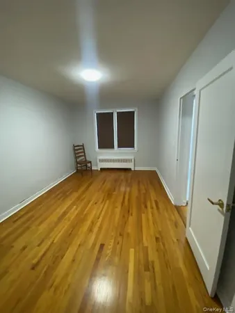 a big room with wooden floor and a bathroom