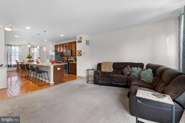 a living room with furniture and kitchen view