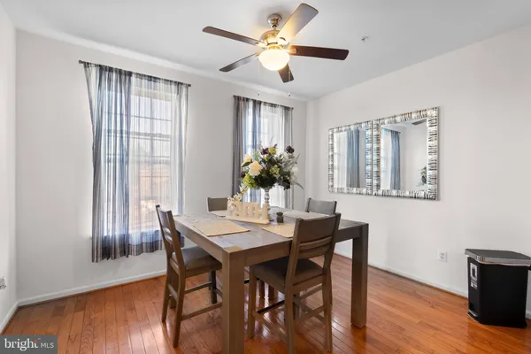 a dining room with furniture a window and wooden floor