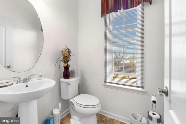 a bathroom with a sink toilet and mirror