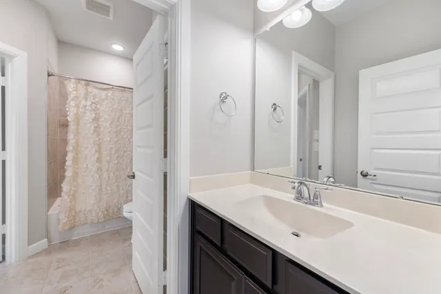 a bathroom with a sink double vanity and a mirror