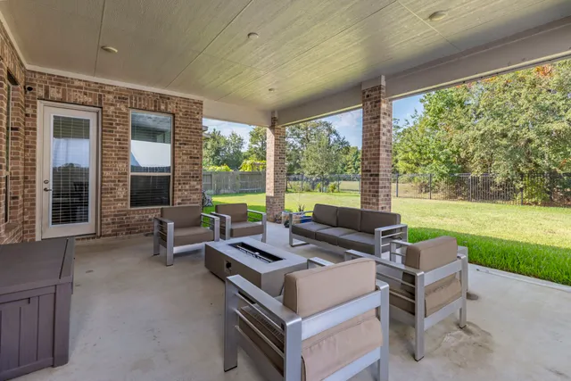 a outdoor space with patio the couches and a dining table with garden view