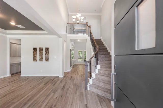 a view of entryway and hall with wooden floor