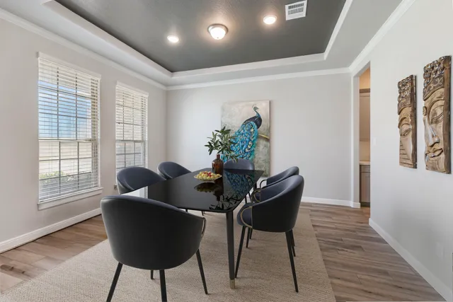 a dining room with furniture and wooden floor